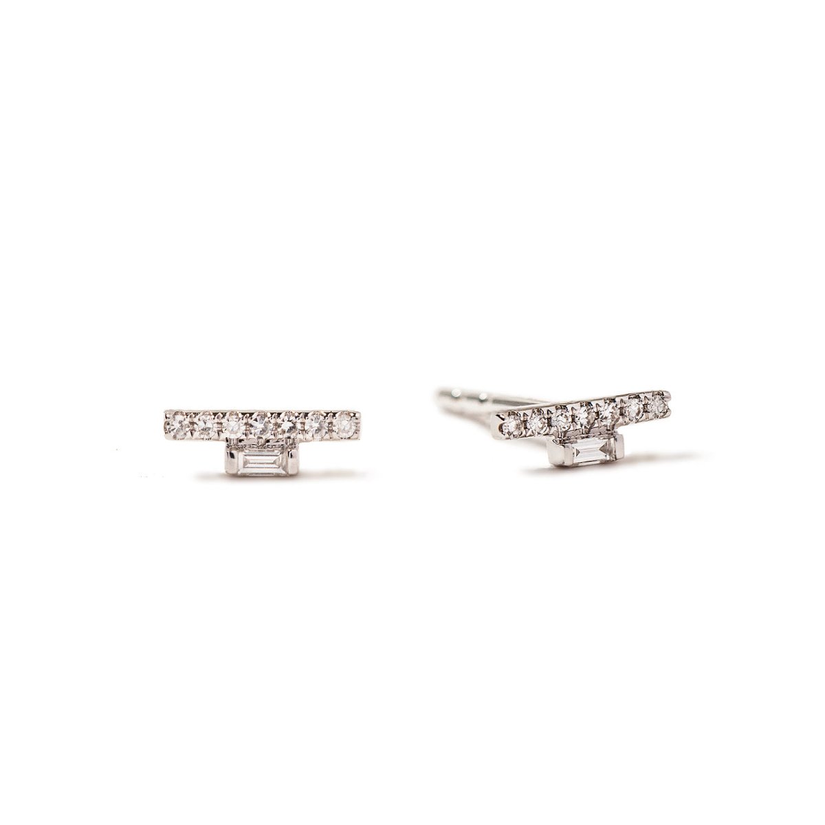 14K white gold pavé bar studs with round and baguette diamonds, on a white background