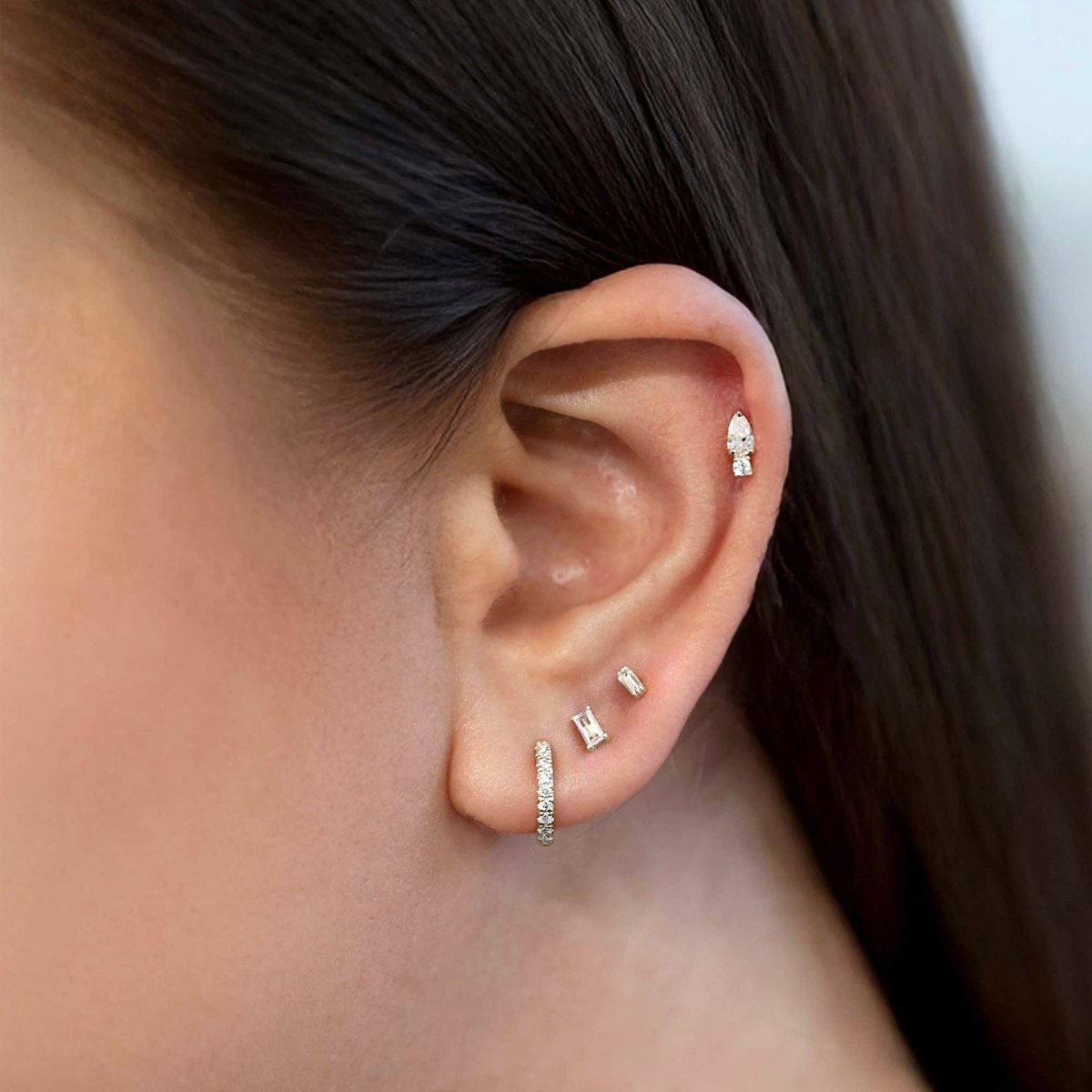 14K white gold baguette flat back stud with a clear baguette stone, close-up on a white background