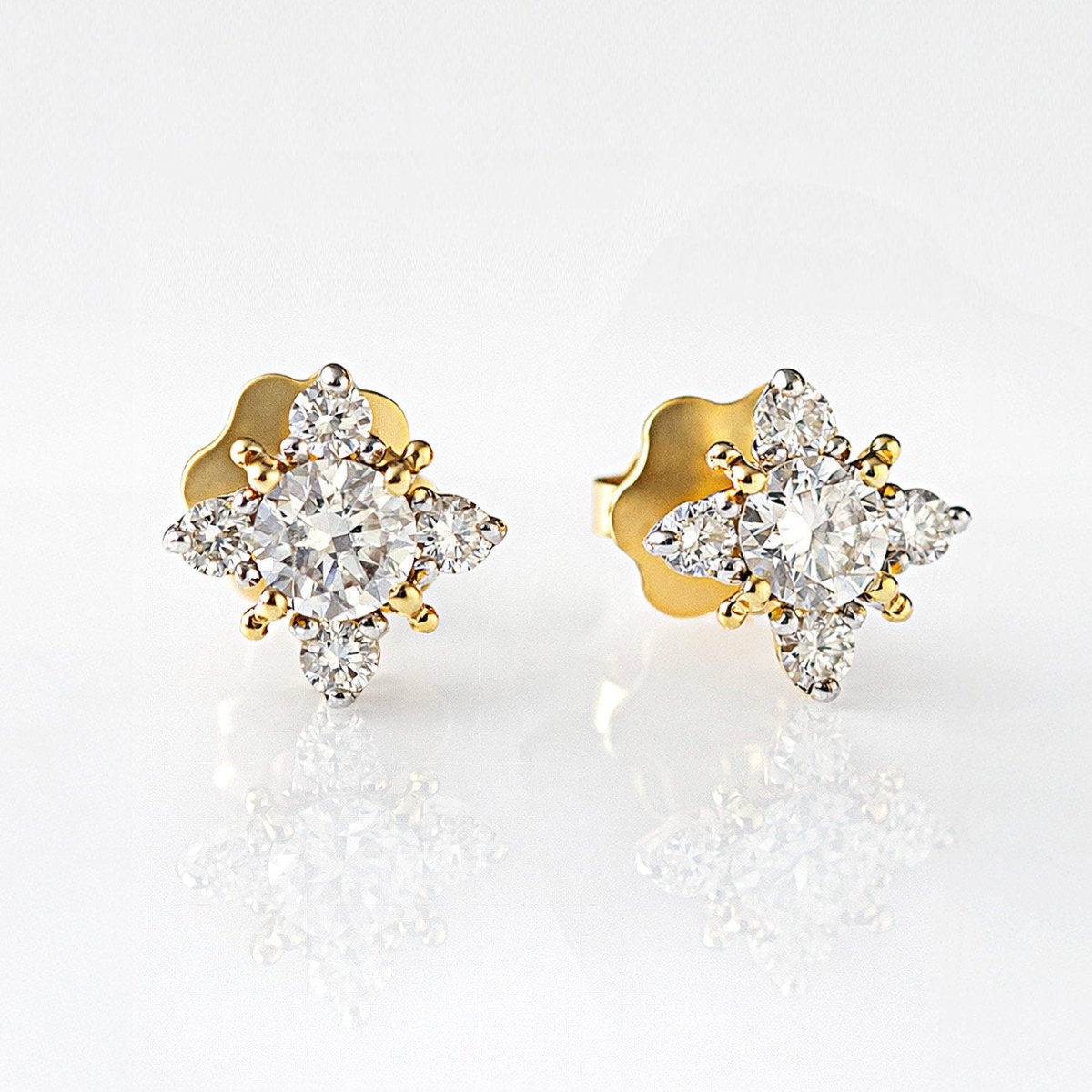 14K gold natural diamond starburst studs in a four-point cluster, close-up detail on a white background