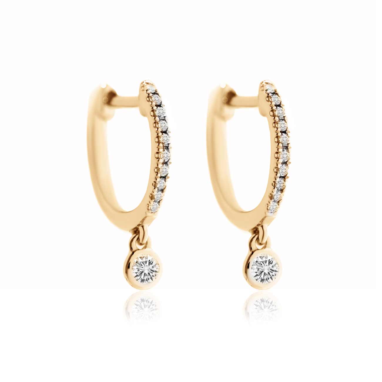 14K gold pavé huggie hoops with a dangling bezel-set diamond drop, on a white background