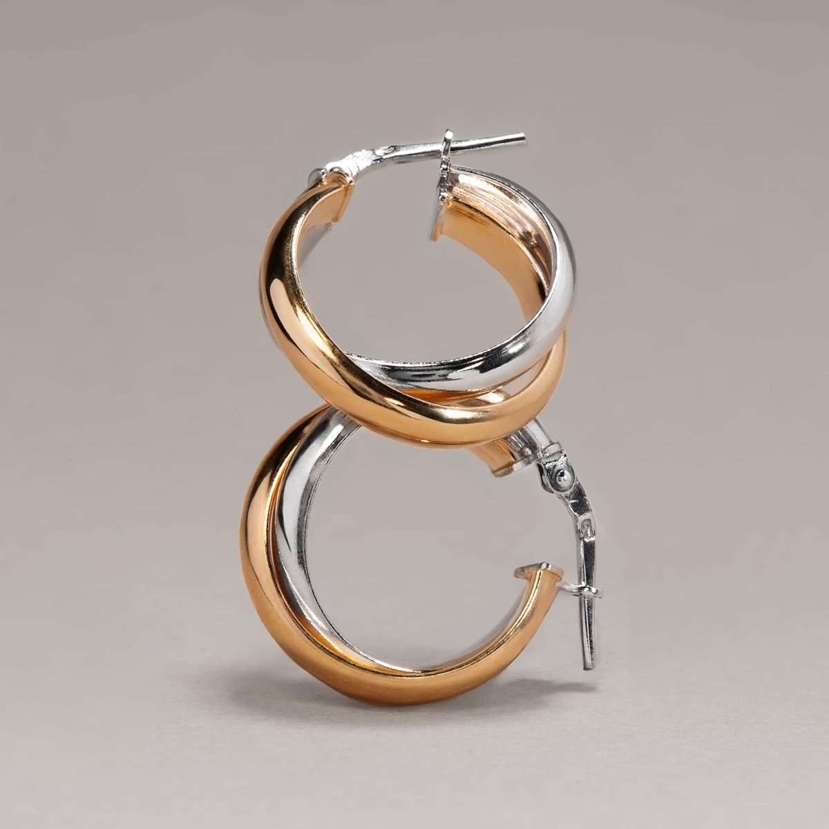 Gold vermeil and silver interlocked twist hoop, close-up detail standing upright