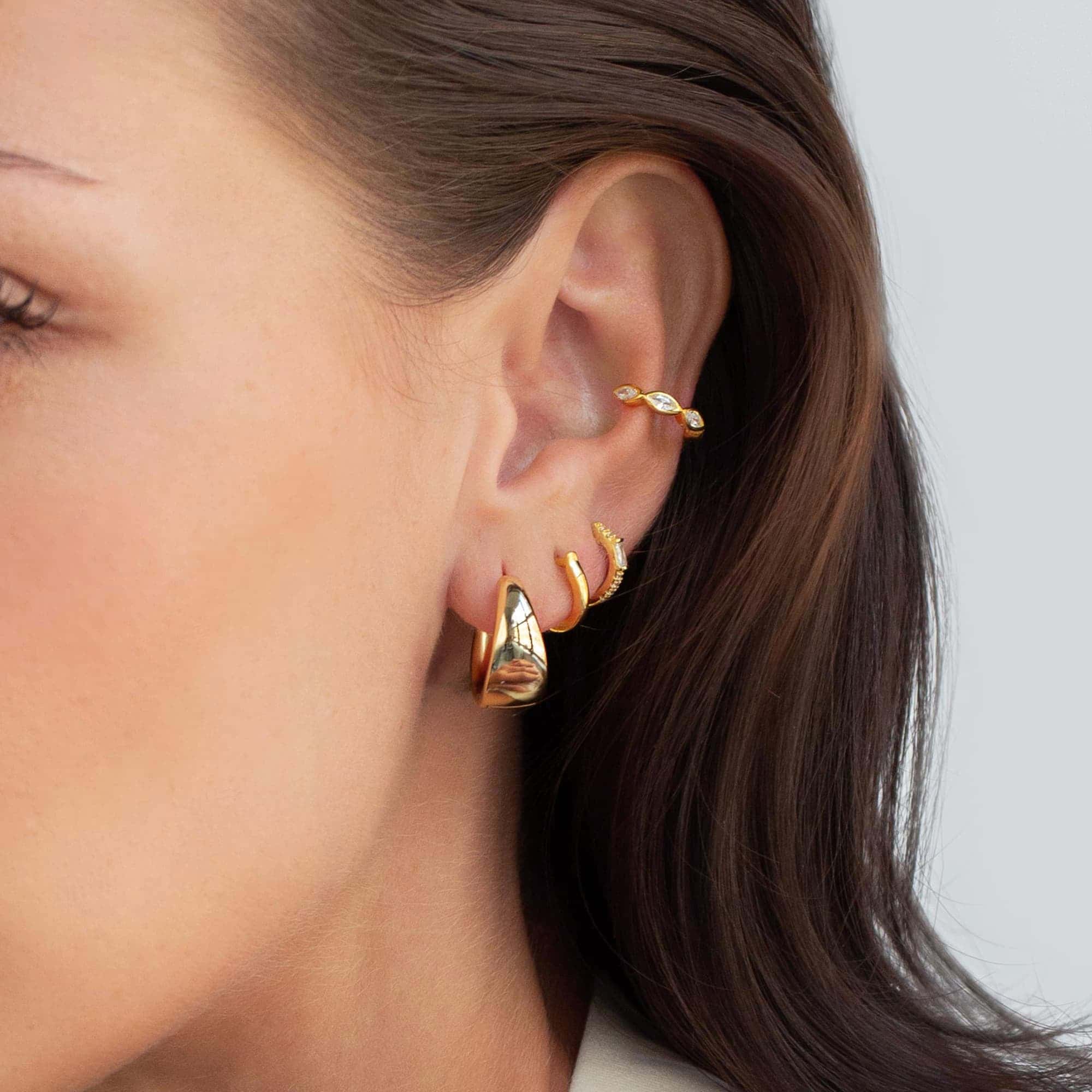 Gold vermeil marquise eternity ear cuff with white zirconia, shown on a model's outer ear
