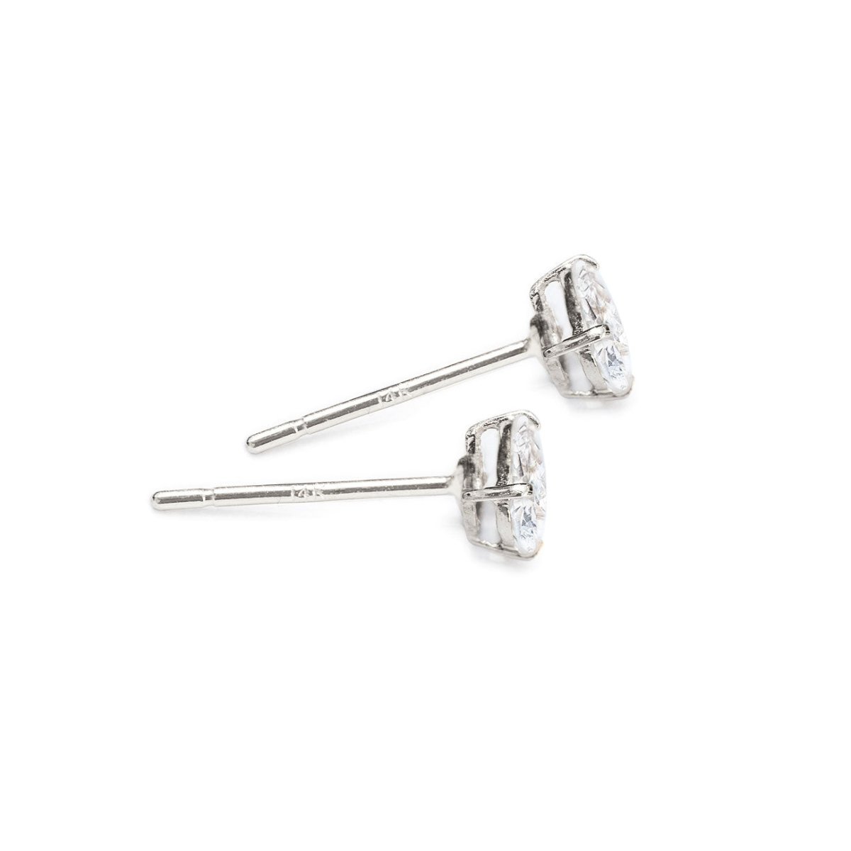 14K white gold oval white zirconia studs shown from the side with posts, on a white background