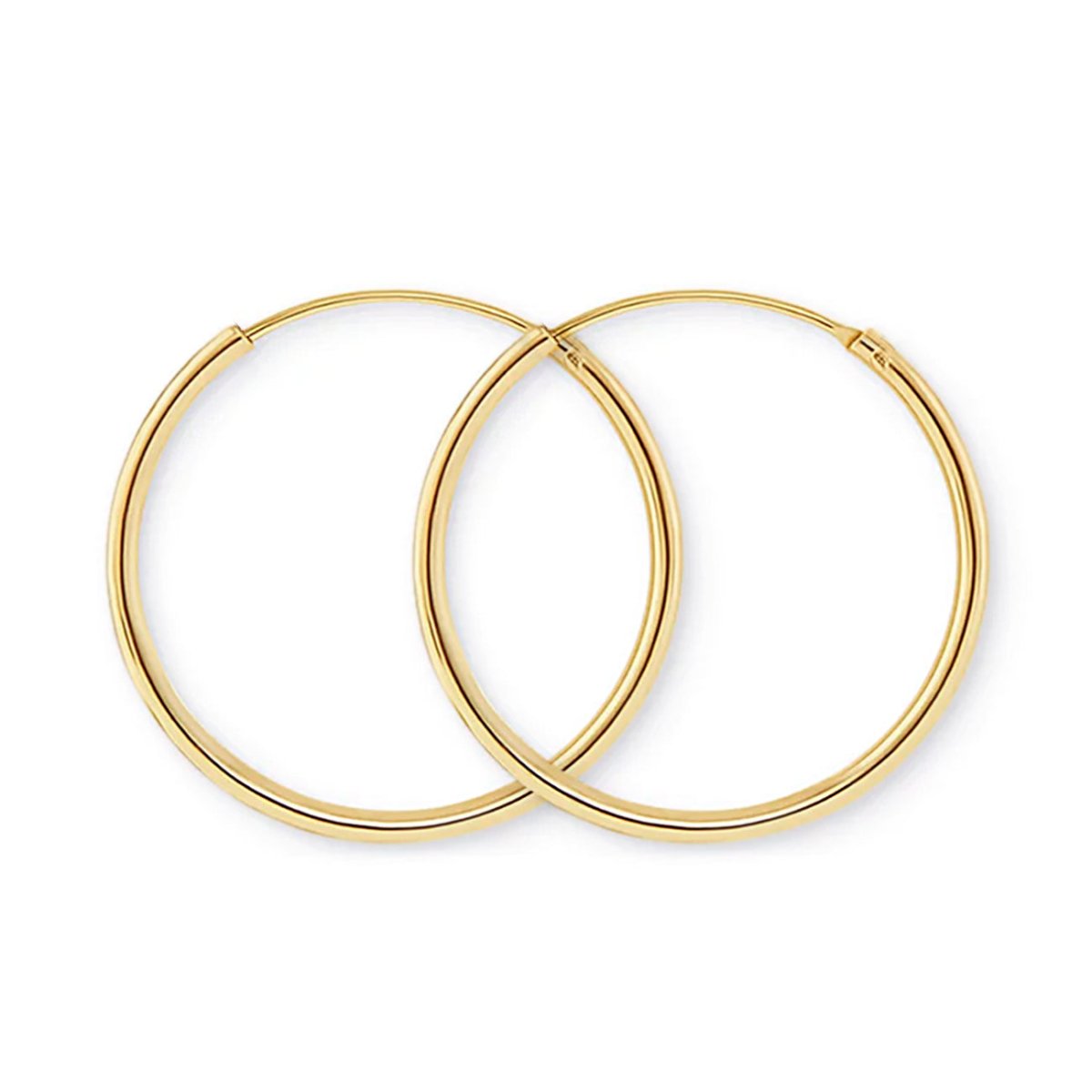 Pair of 14K gold thin midi hoops with an endless tube closure, on a white background