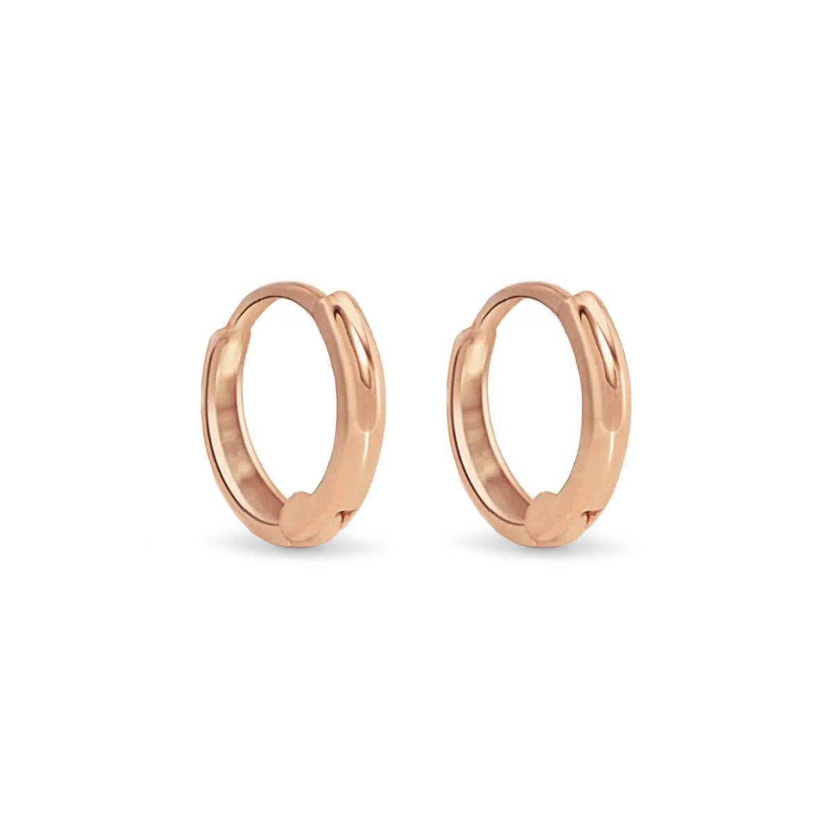 Pair of 14K rose gold mini huggie hoop earrings with a hinged closure, on a white background