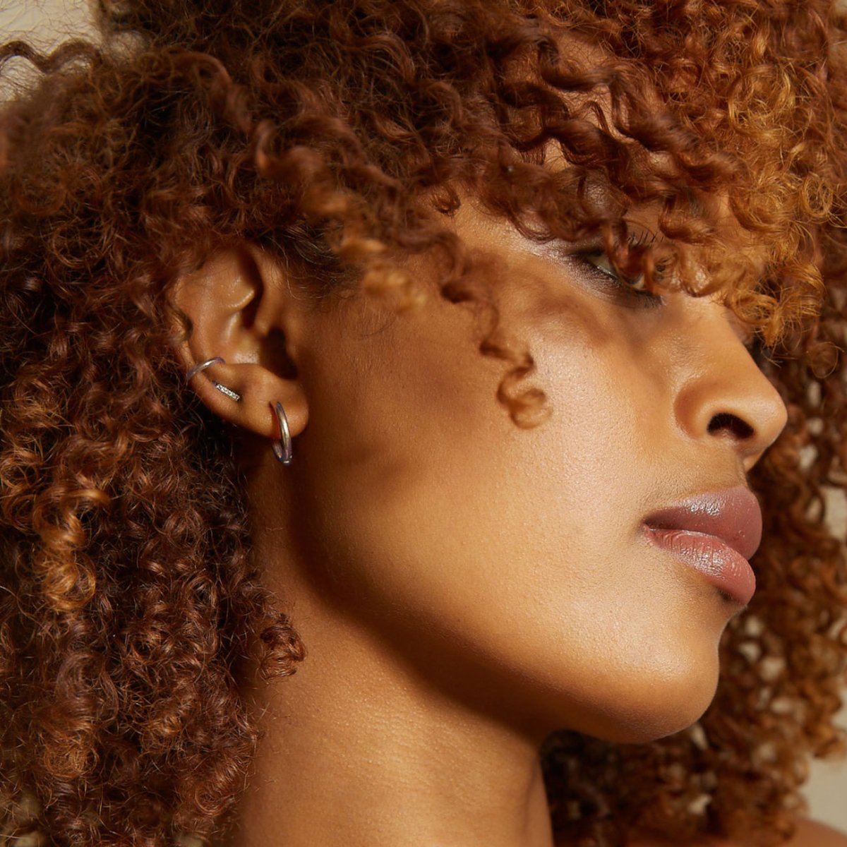 14K white gold jewelry shown on a model's ear and lobe in profile, close-up view