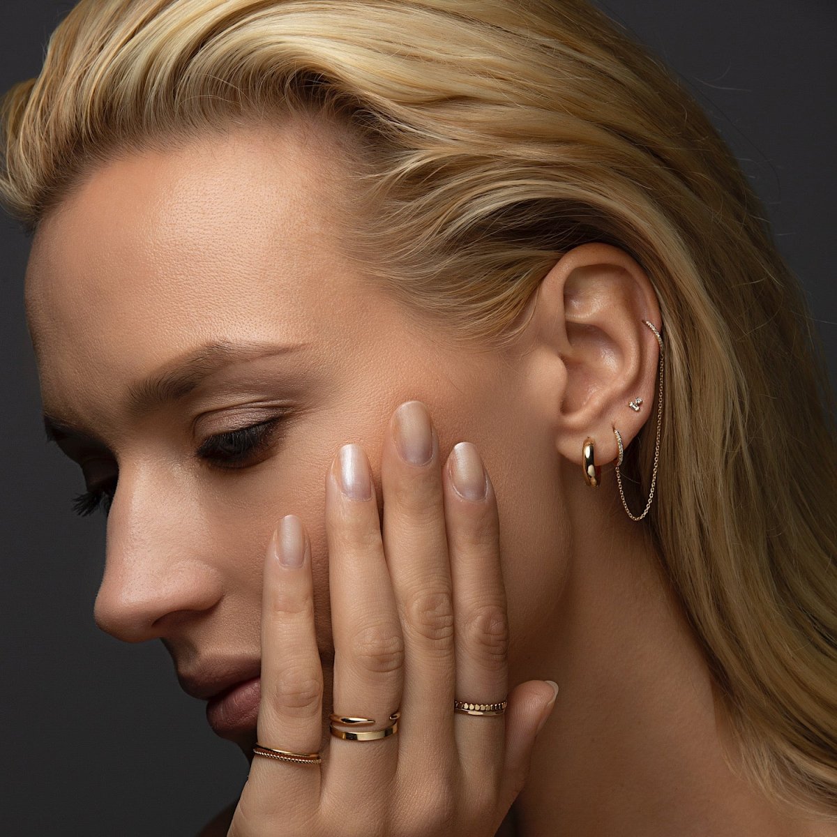 14K gold diamond double huggie chain earring shown on a model's ear