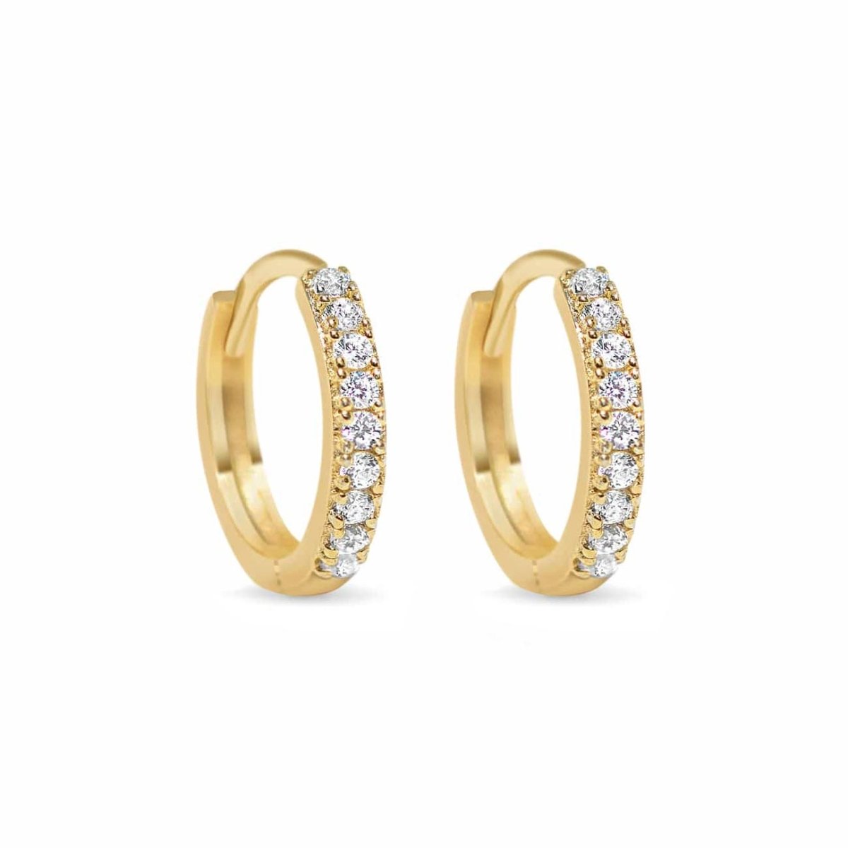 Pair of 14K gold pavé huggie hoops set with round clear stones, on a white background