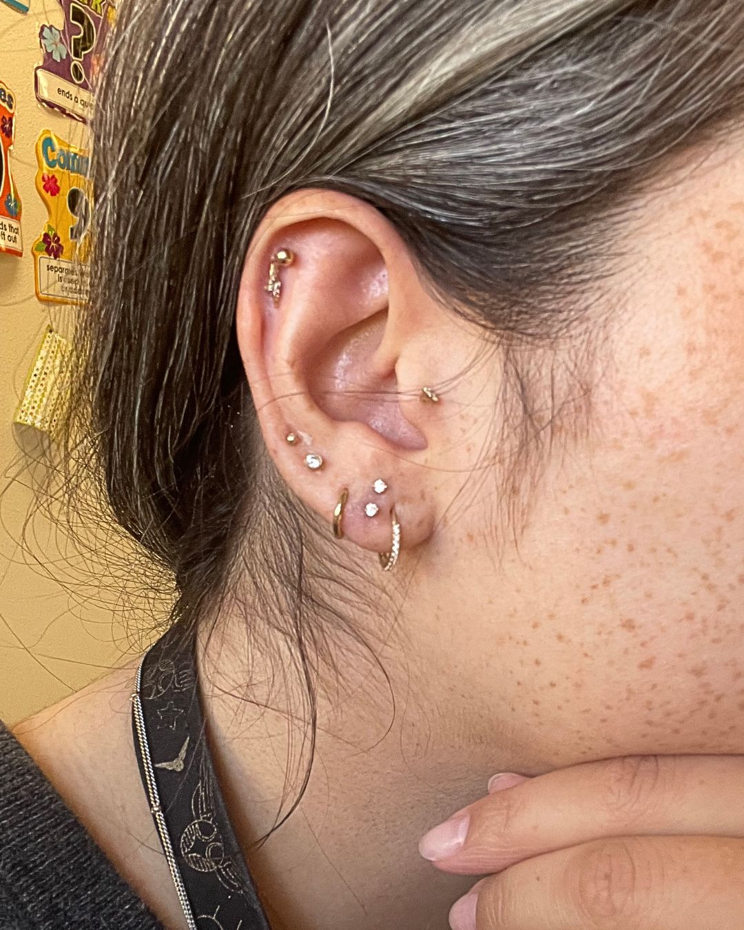 Curated ear with gold studs, a plain hoop and a crystal-set huggie hoop across lobe, helix and forward helix