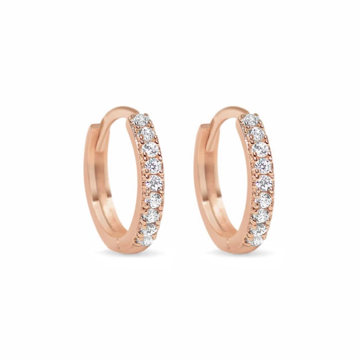 Pair of rose gold vermeil pavé huggie hoops set with round clear stones, on a white background