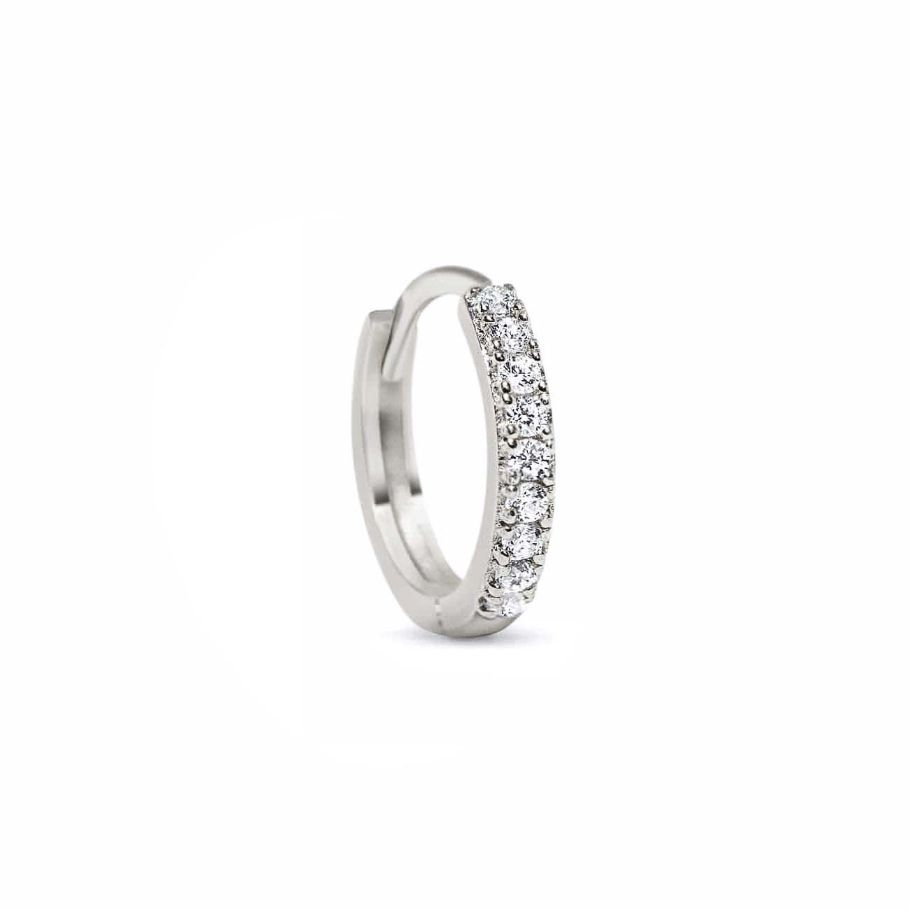 14K white gold pavé huggie hoop set with round clear stones, on a white background