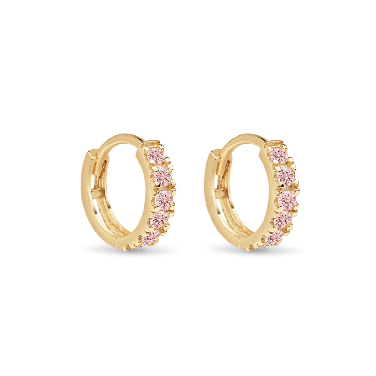 Pair of 14K gold pave huggie hoops set with pink sapphire stones, on a white background
