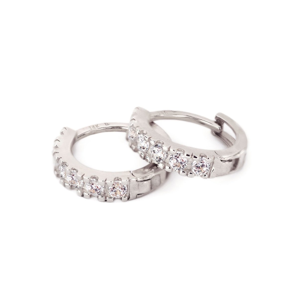 Close-up of 14k white gold pave huggie earrings