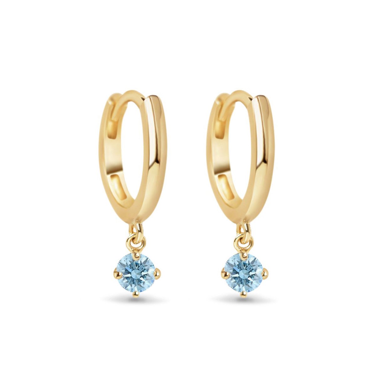 Pair of 14K gold huggie hoops with dangling round aquamarine stones, on a white background
