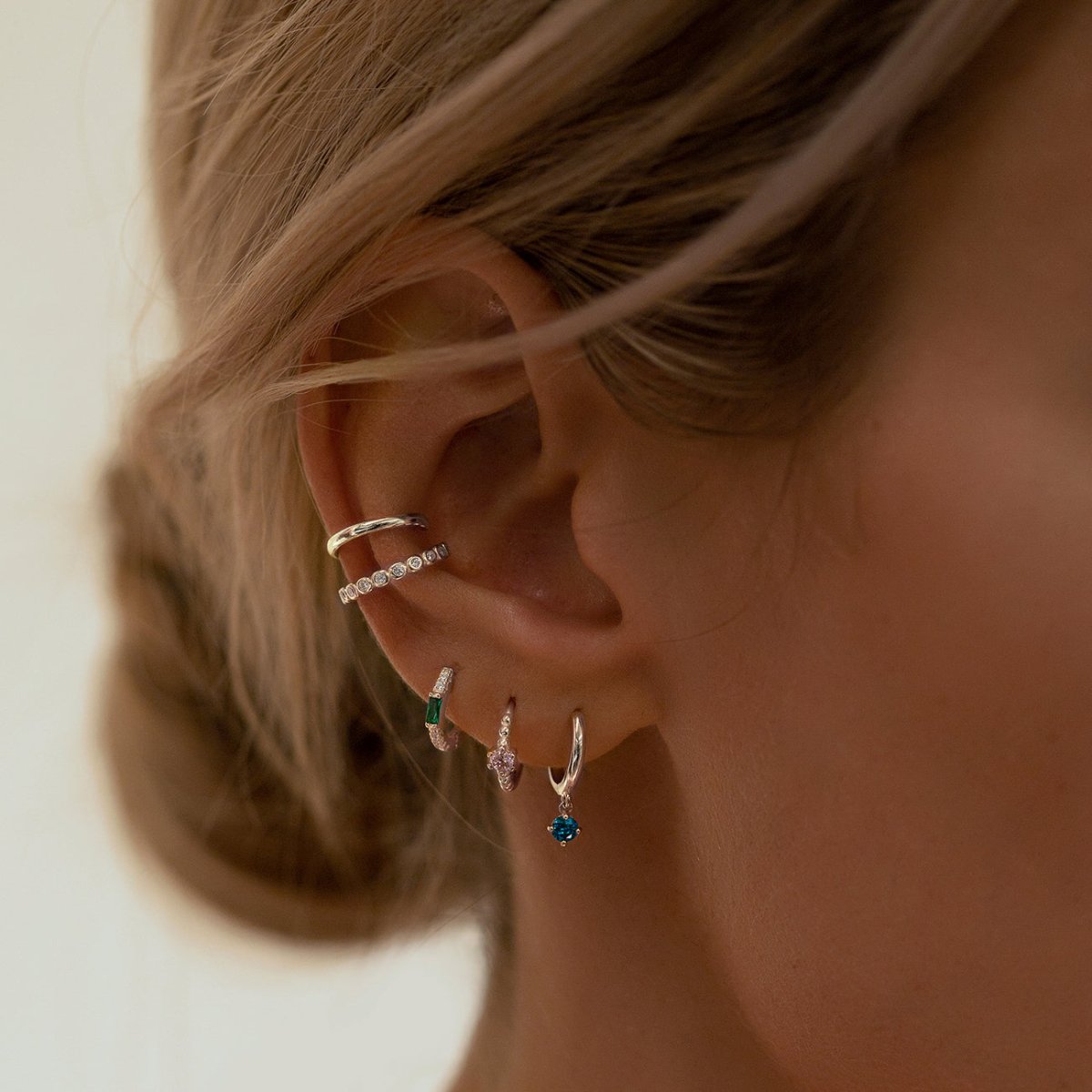 Sterling silver white zirconia ear conch cuffs shown on a model's conch in an ear stack