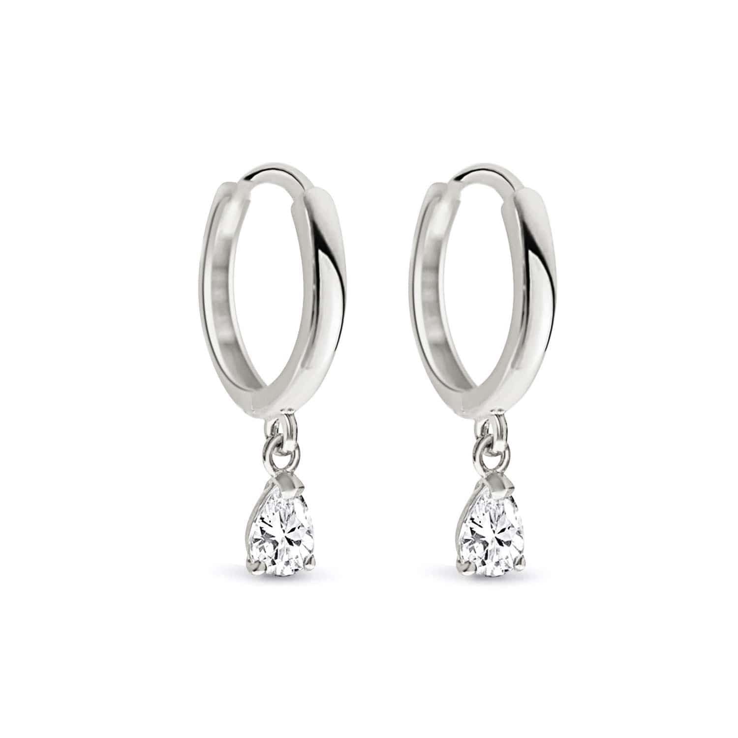 14K white gold huggie hoops with dangling pear-cut moissanite drops, on a white background