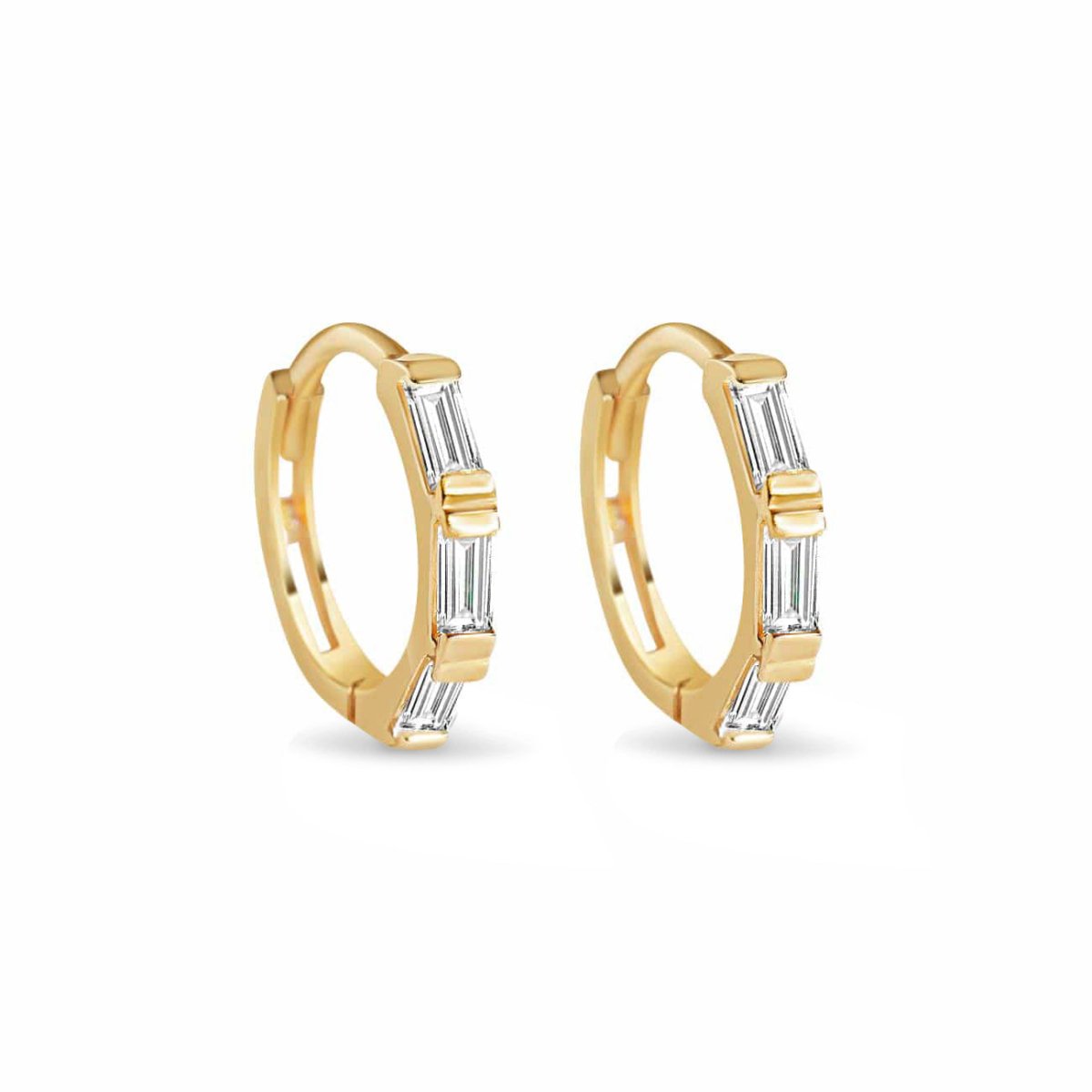 Gold vermeil baguette huggie hoops with three clear stones, on a white background
