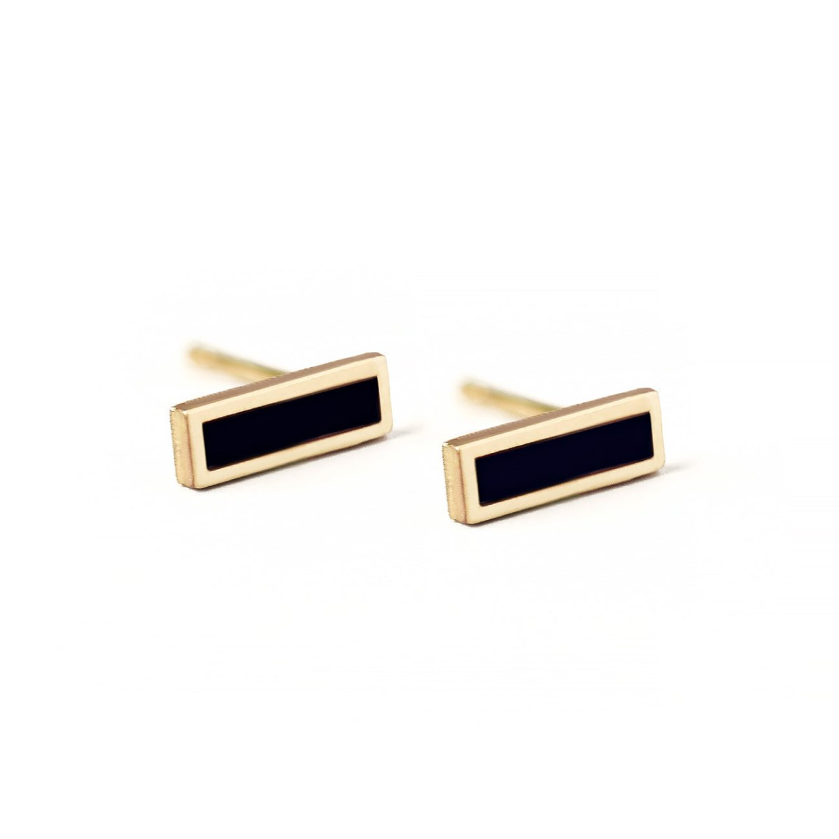 Pair of 14K gold onyx bar studs with black rectangular stones, on a white background
