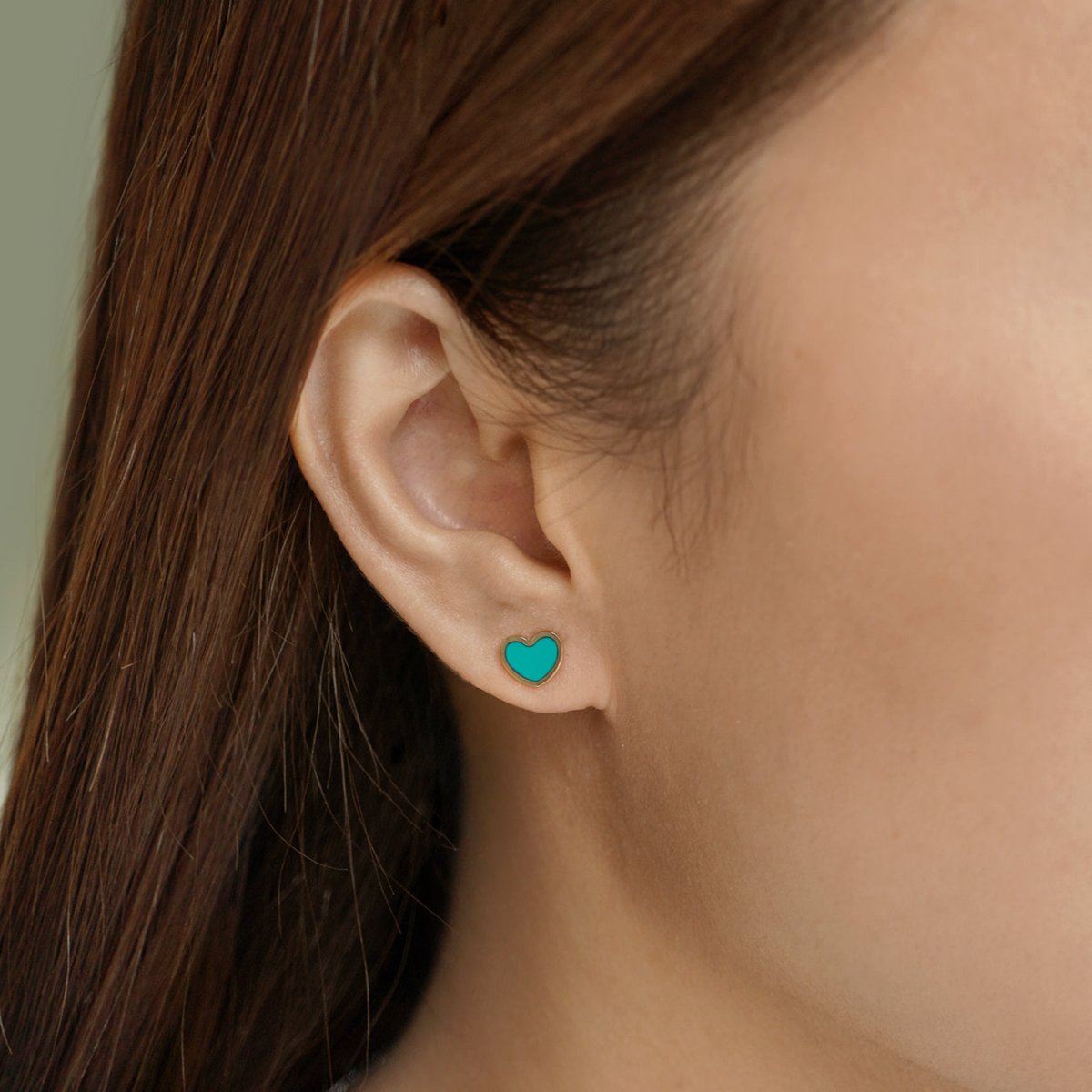 14K gold turquoise heart stud, shown on a model's lobe