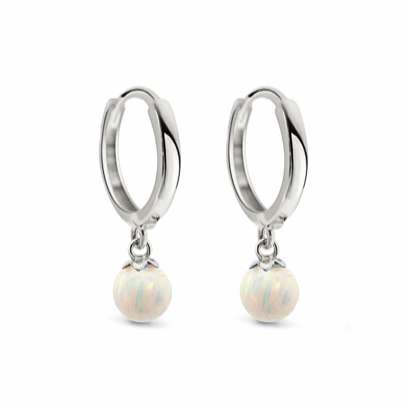 14K white gold huggie hoops with dangling white opal beads, on a white background