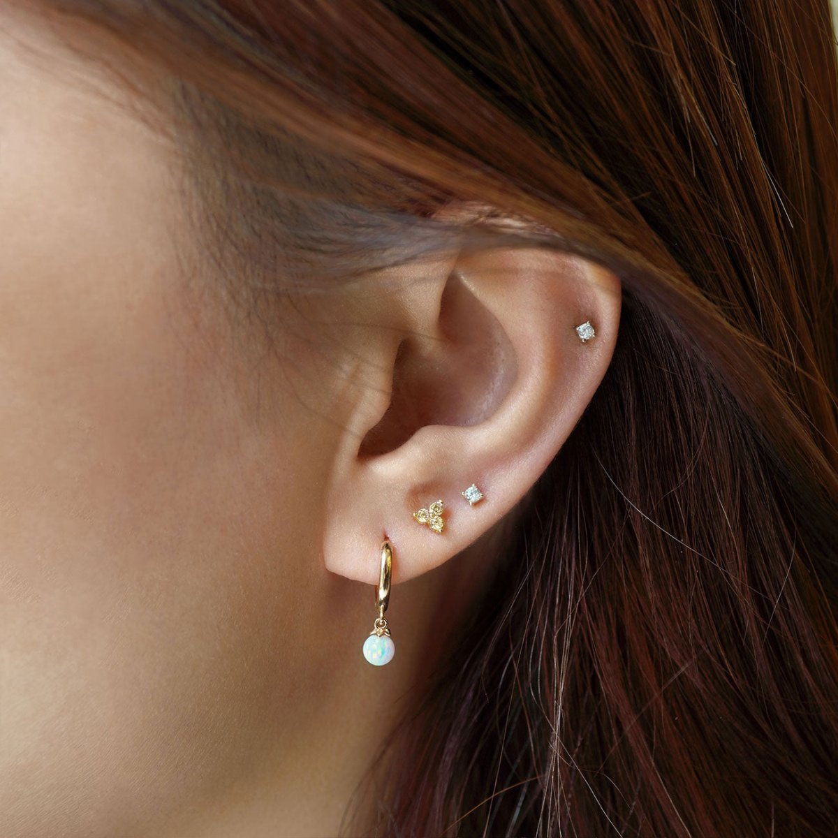 Close up of woman's ear featuring Gold Vermeil Birthstone Studs Set Citrine and opal hoop earring 
