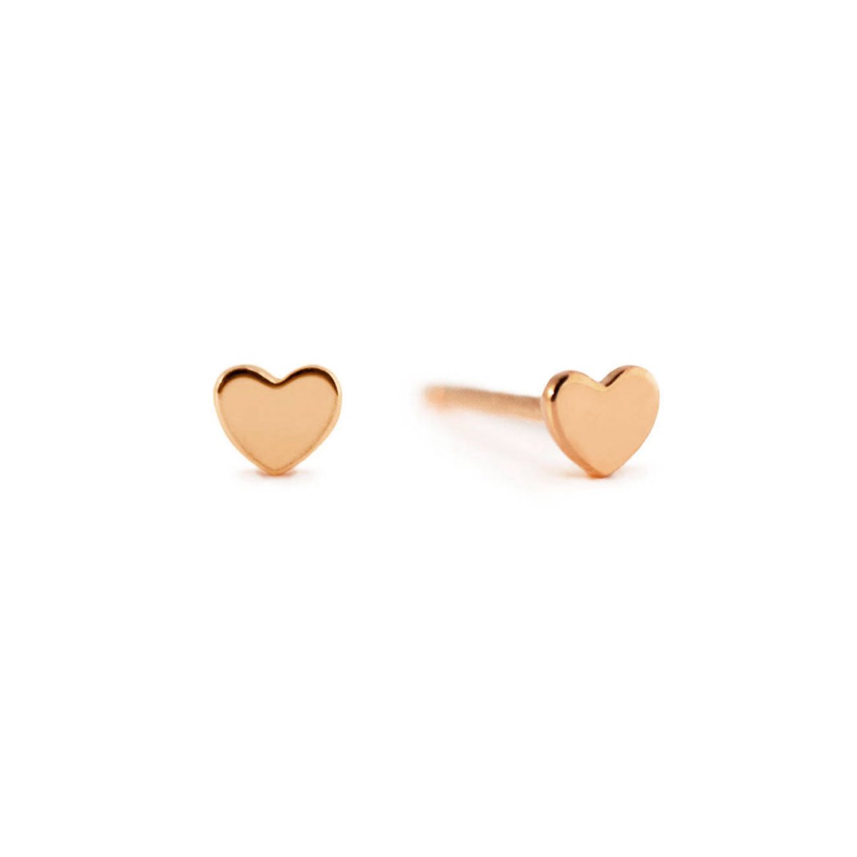 Pair of 14K rose gold tiny heart studs with flat heart tops, on a white background