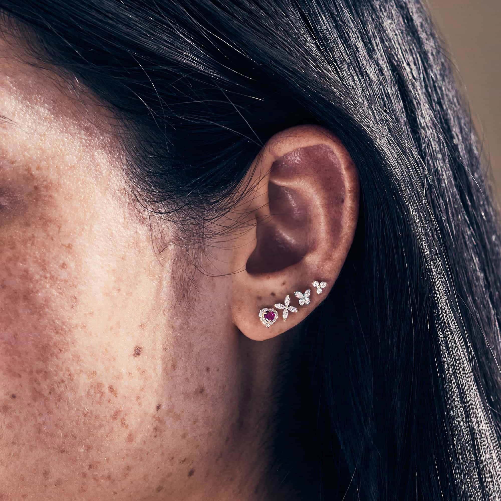 14K white gold crystal butterfly stud styled in a curved lobe stack on a model