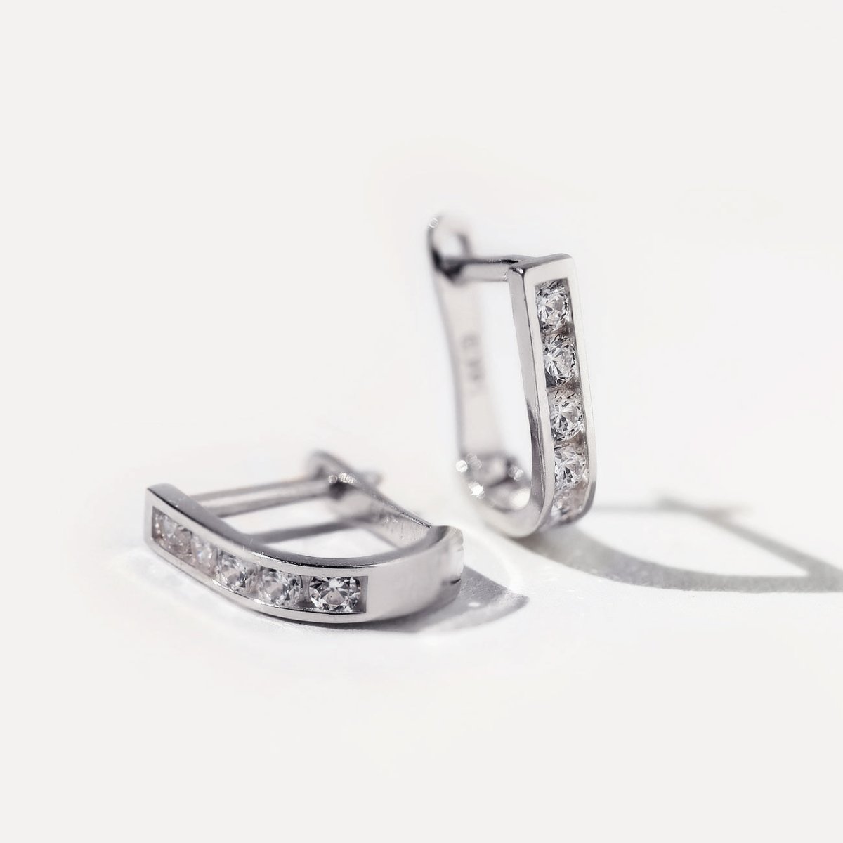 14K white gold huggie hoops channel-set with clear white zirconia, close-up detail
