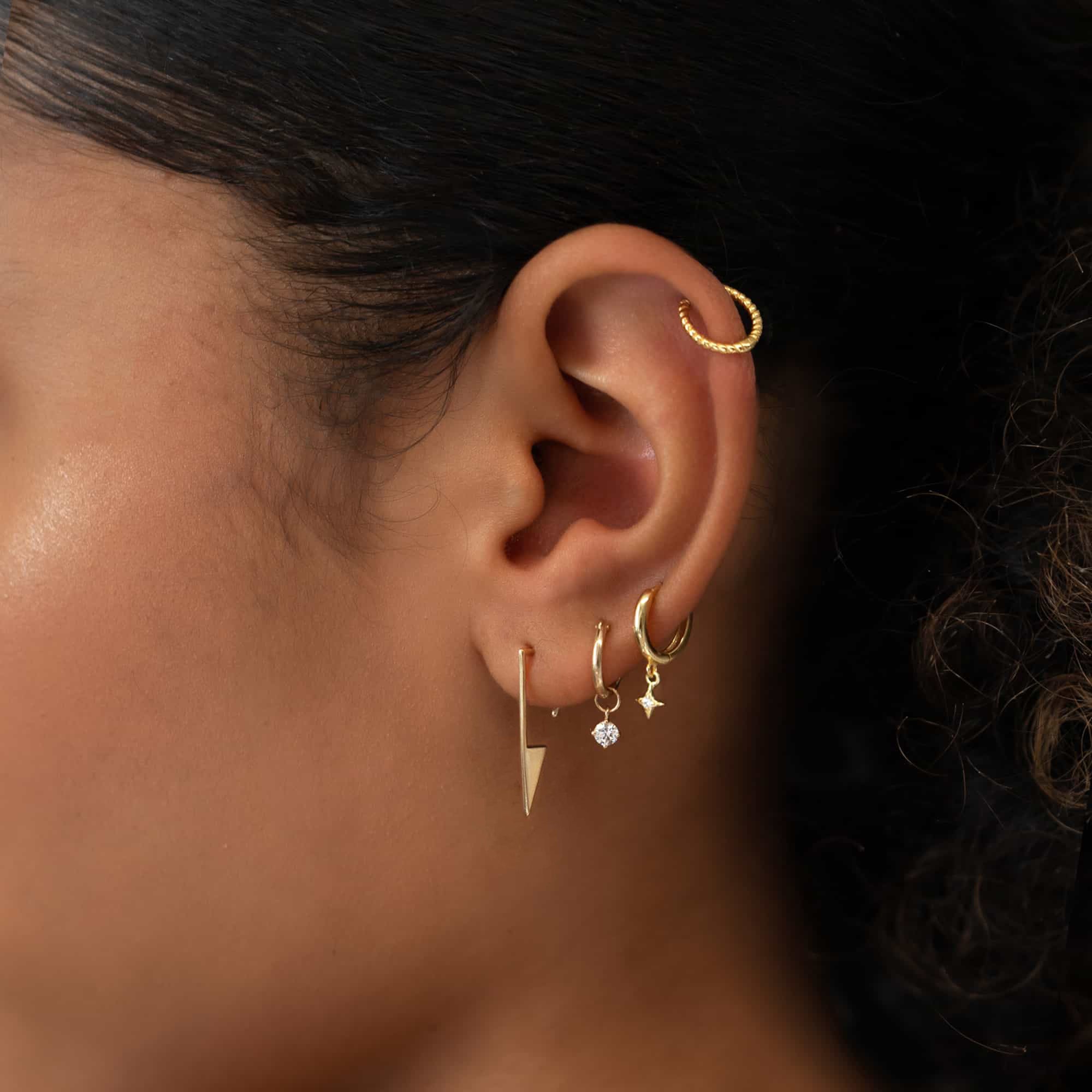 Pair of 14K gold open triangle drop earrings shown loose on a white background