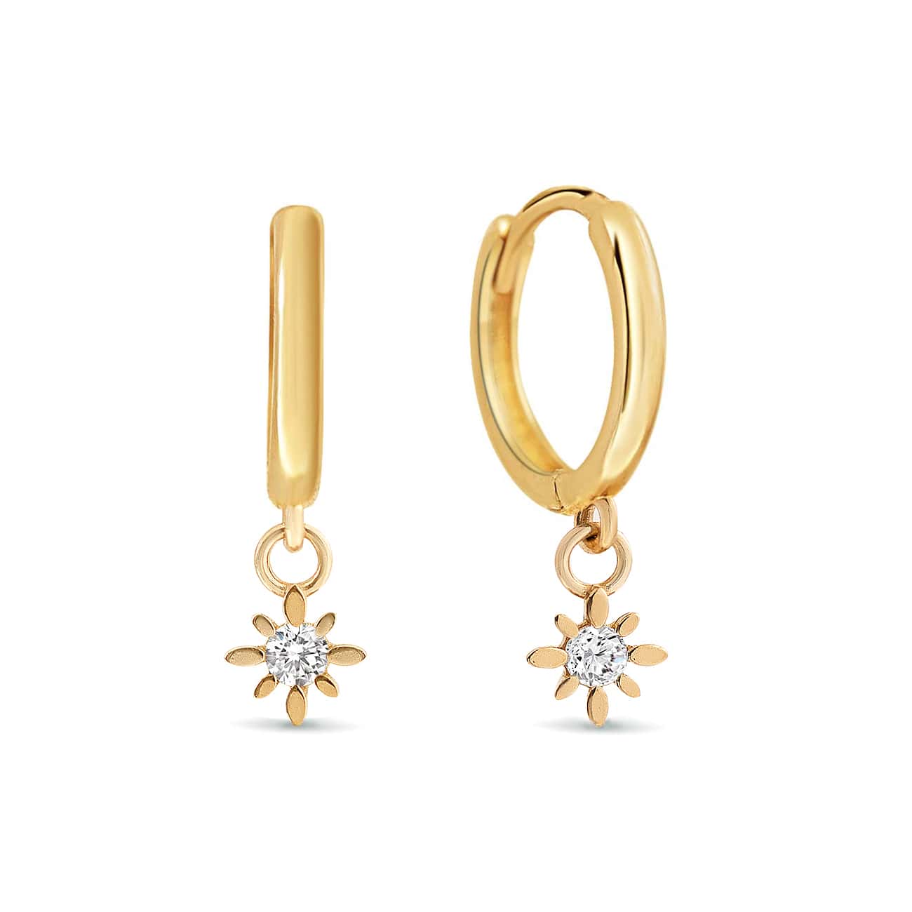 Pair of 14K gold huggie hoops with dangling starburst zirconia charms, on a white background