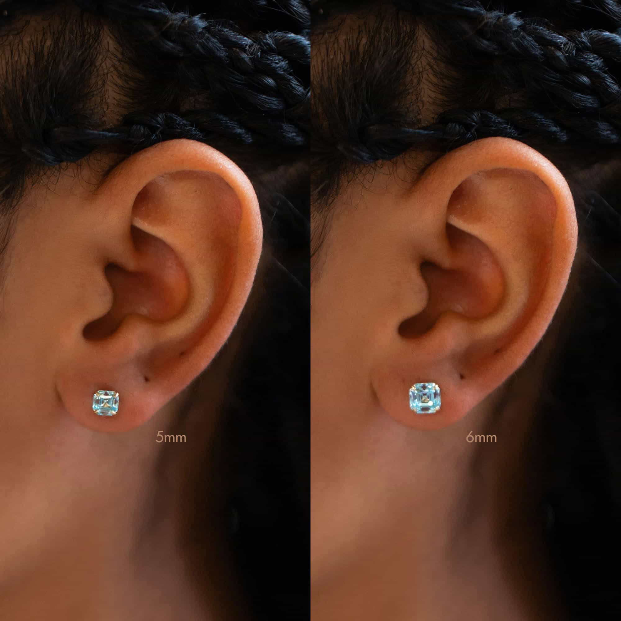 14K gold aquamarine stud on a model's lobe, size comparison of 5mm and 6mm light blue stones