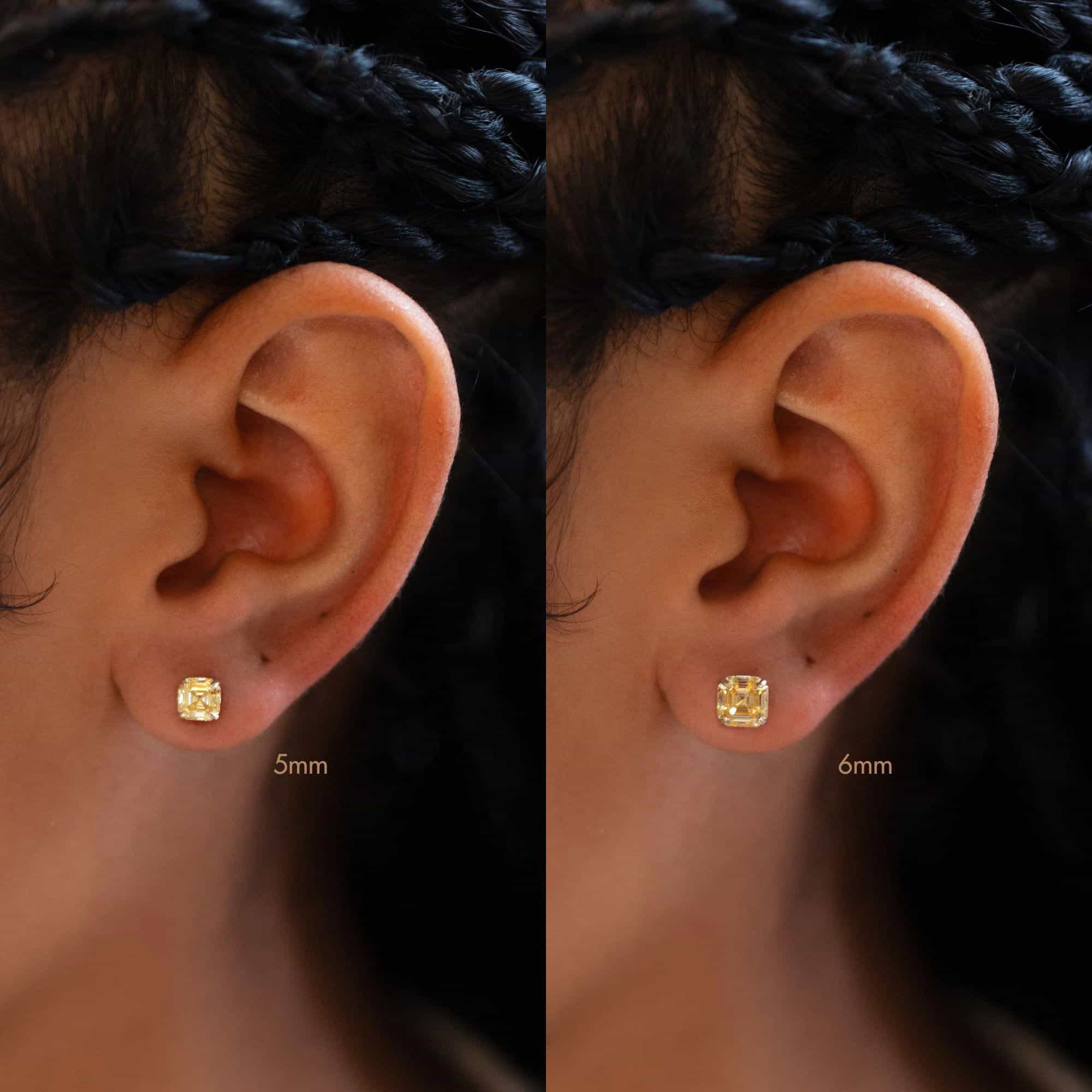 14K gold citrine stud on a model's lobe, size comparison of 5mm and 6mm yellow stones