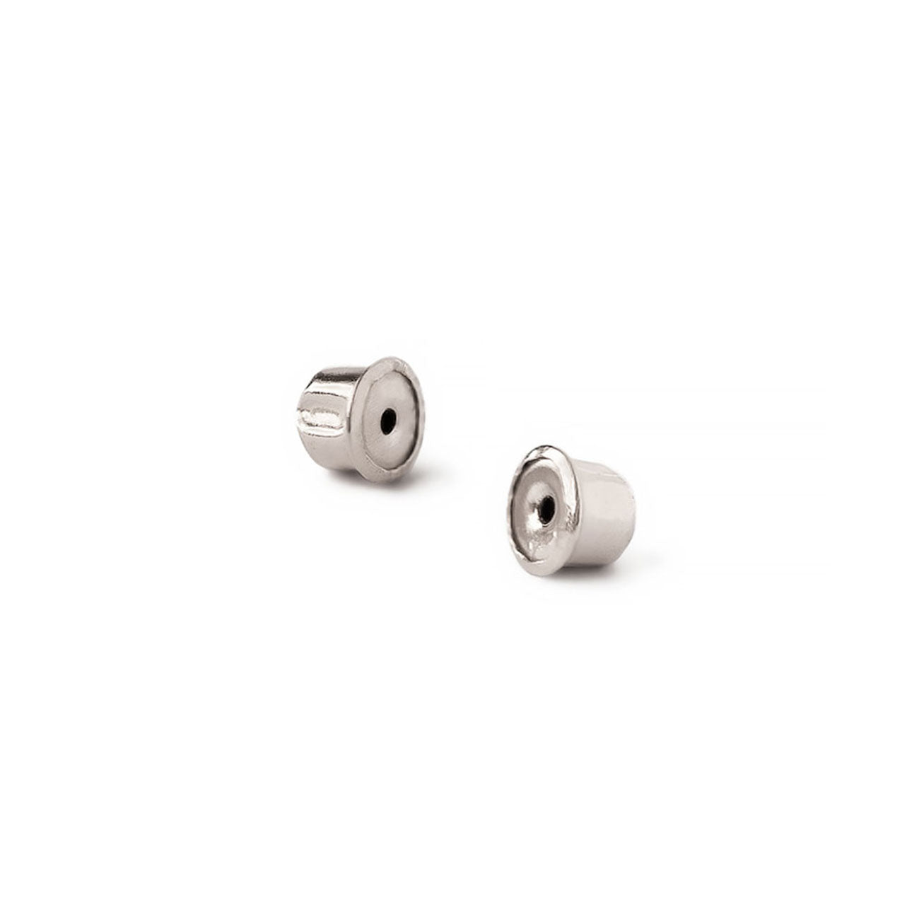 Pair of silver earring backs for the white gold blue sapphire studs, close-up on a white background