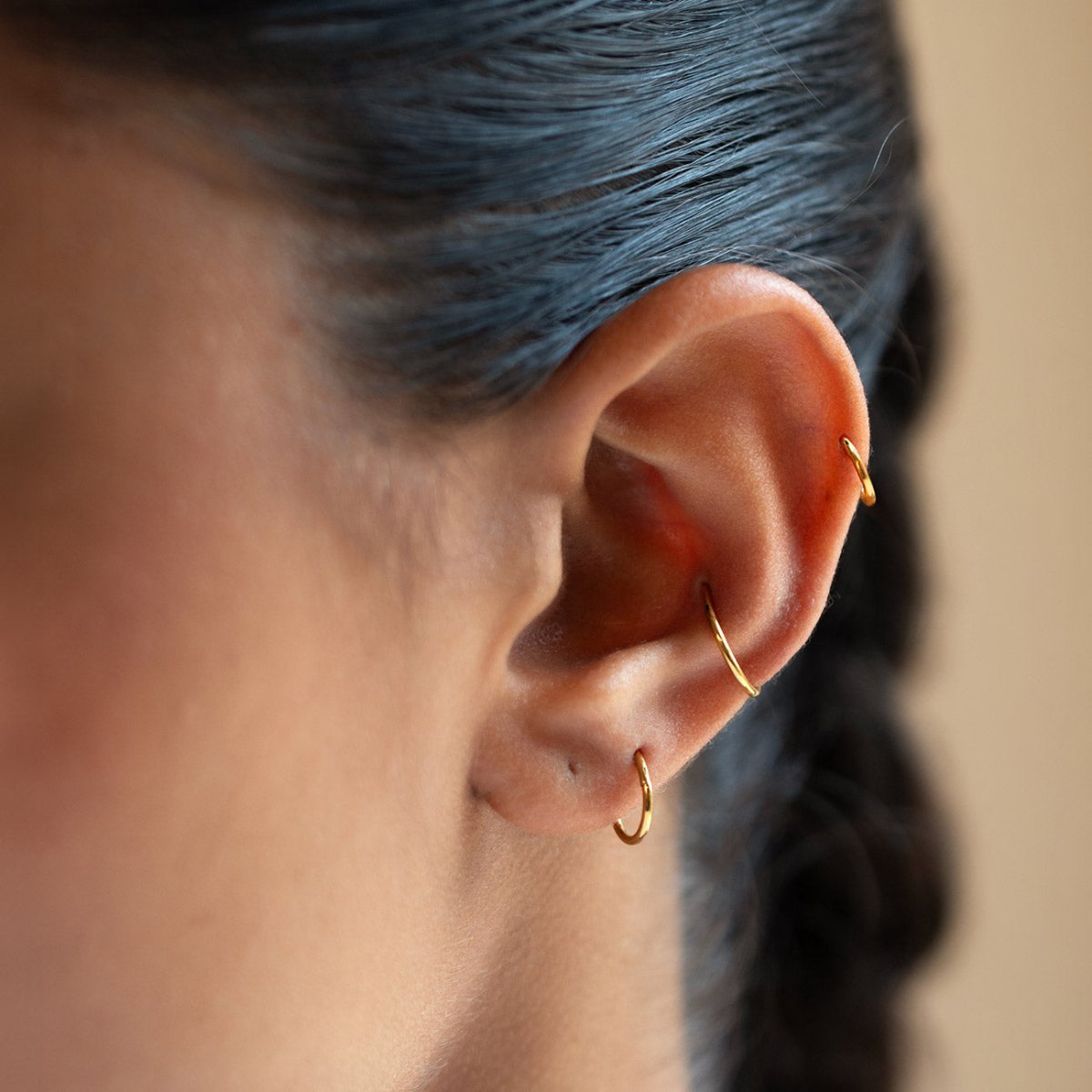 caption: Shown on medium-sized ears: 8mm (2nd hole), 10mm (conch), 6mm (helix).