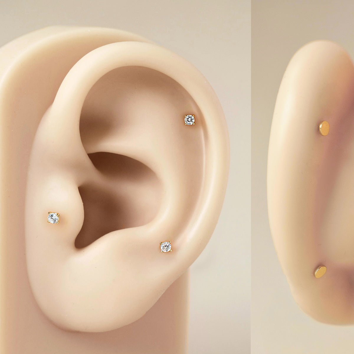 Sterling silver clear zirconia flat back studs shown on a silicone ear model at upper lobe and cartilage