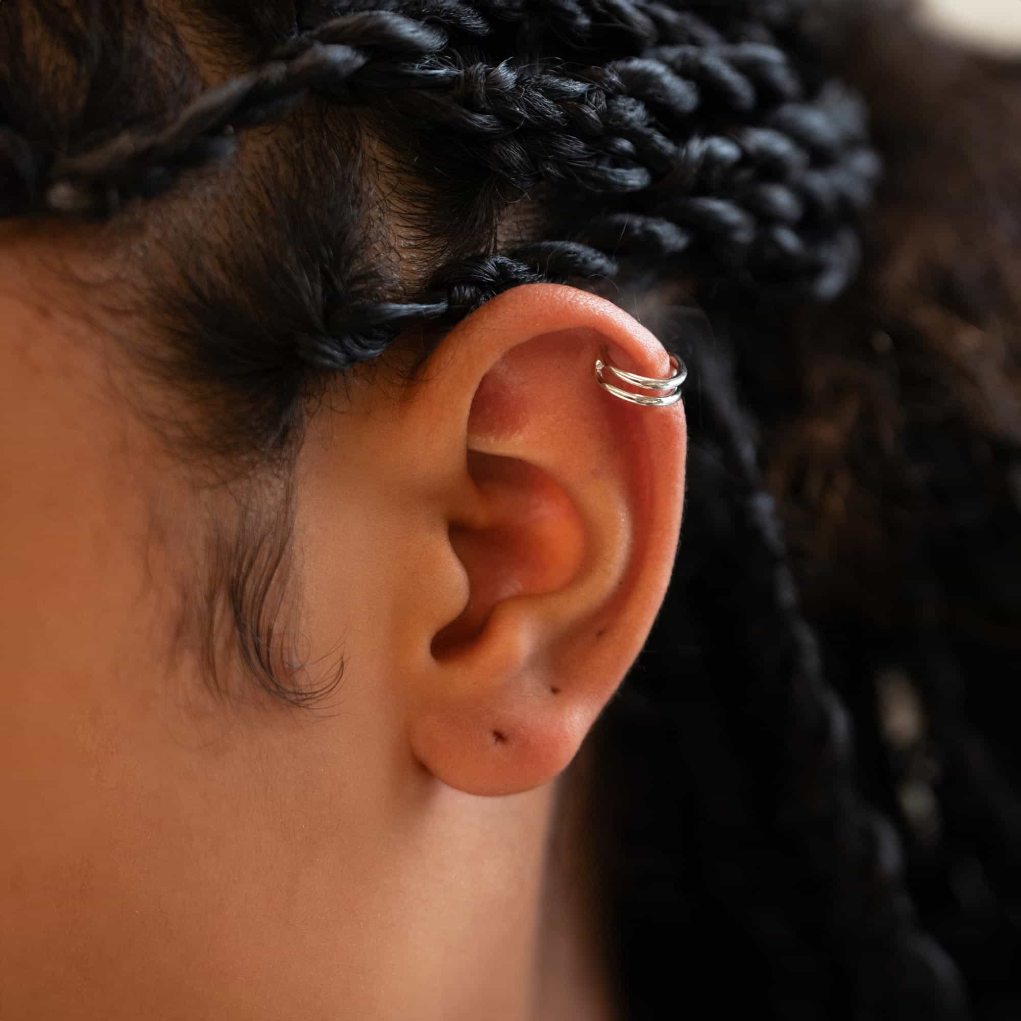 Close up of woman's ear featuring Sterling Silver Double Hoop Cartilage Earring