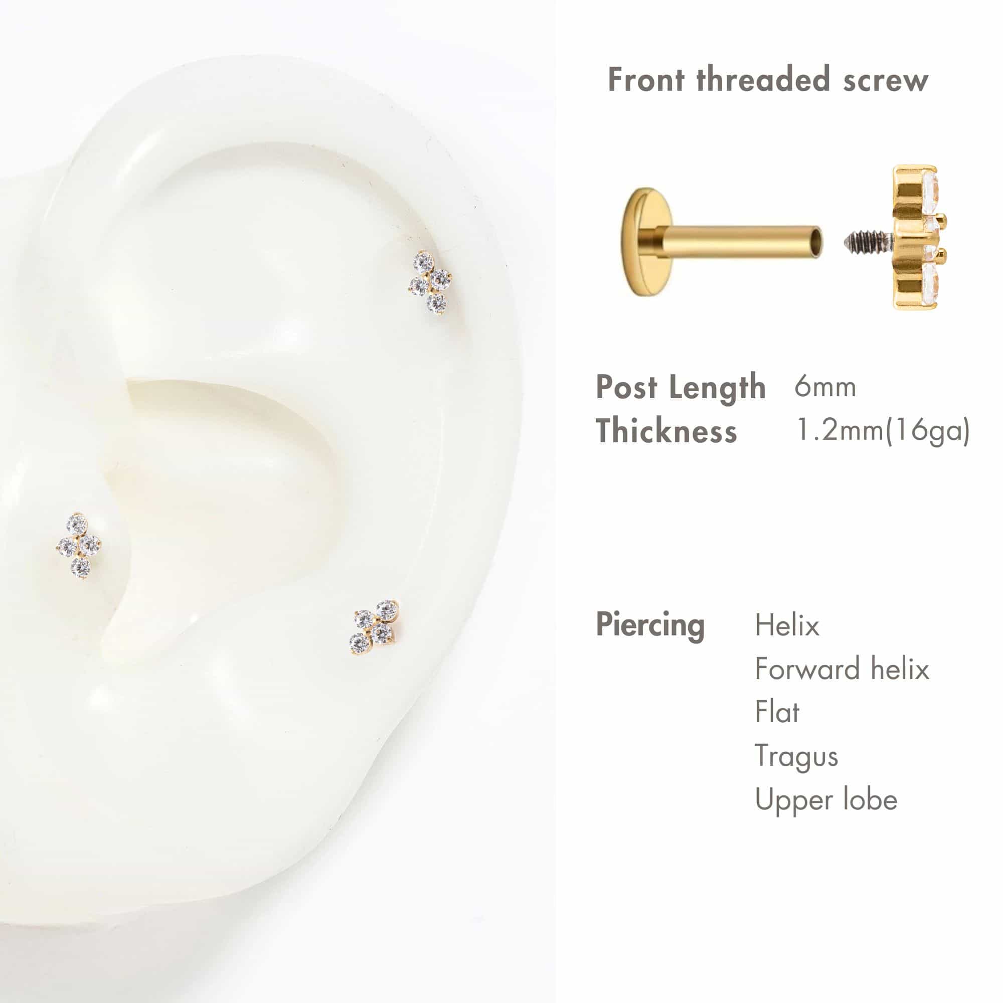 Gold titanium trinity flat back studs with three clear stones, shown on a white ear display with piercing guide