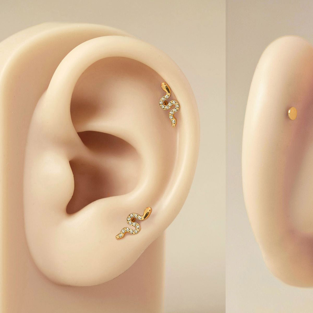 Gold titanium pavé serpent flat back studs with clear stones, shown on an ear model in two placements