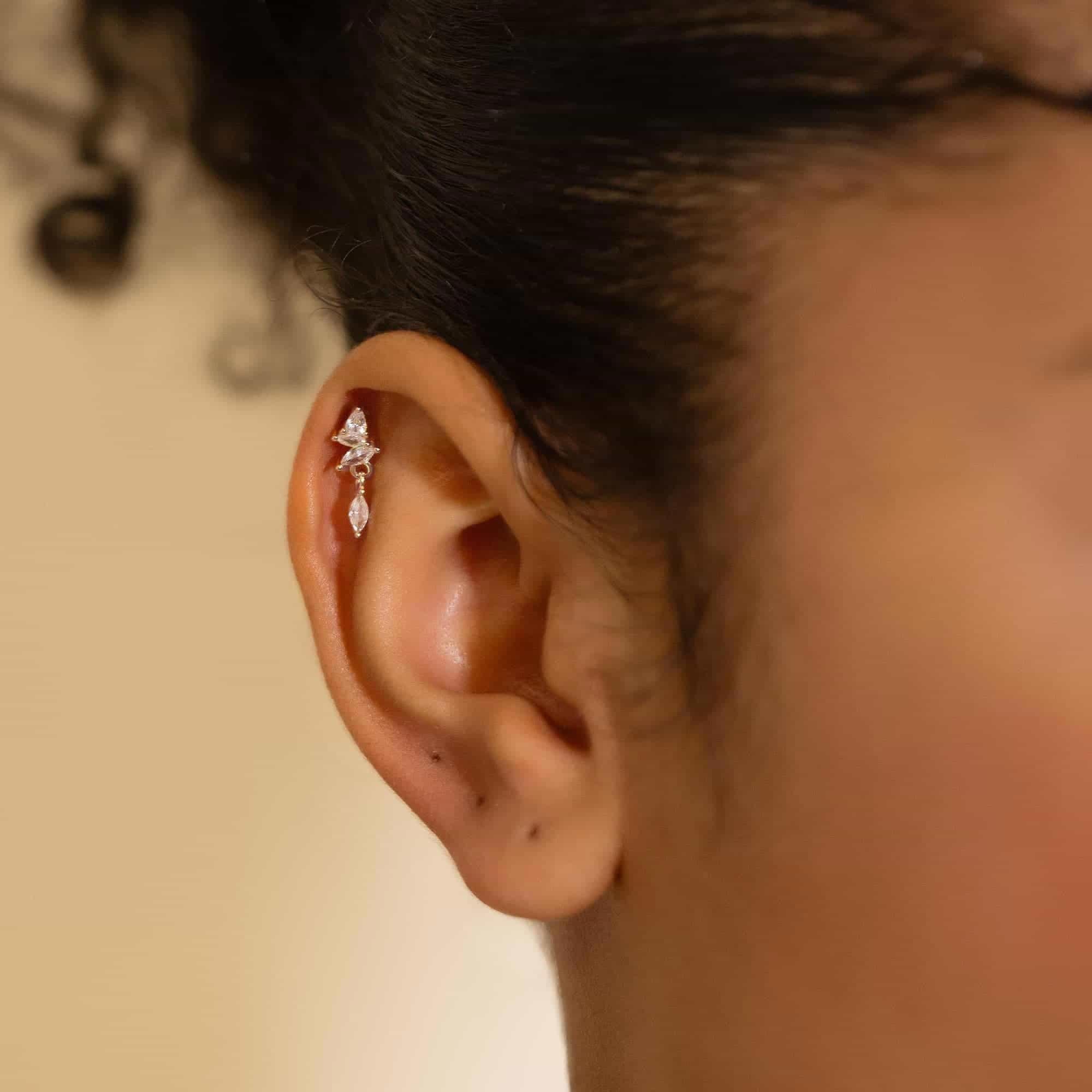 Sterling silver marquise white zirconia cluster flat back stud, shown in a model's helix piercing