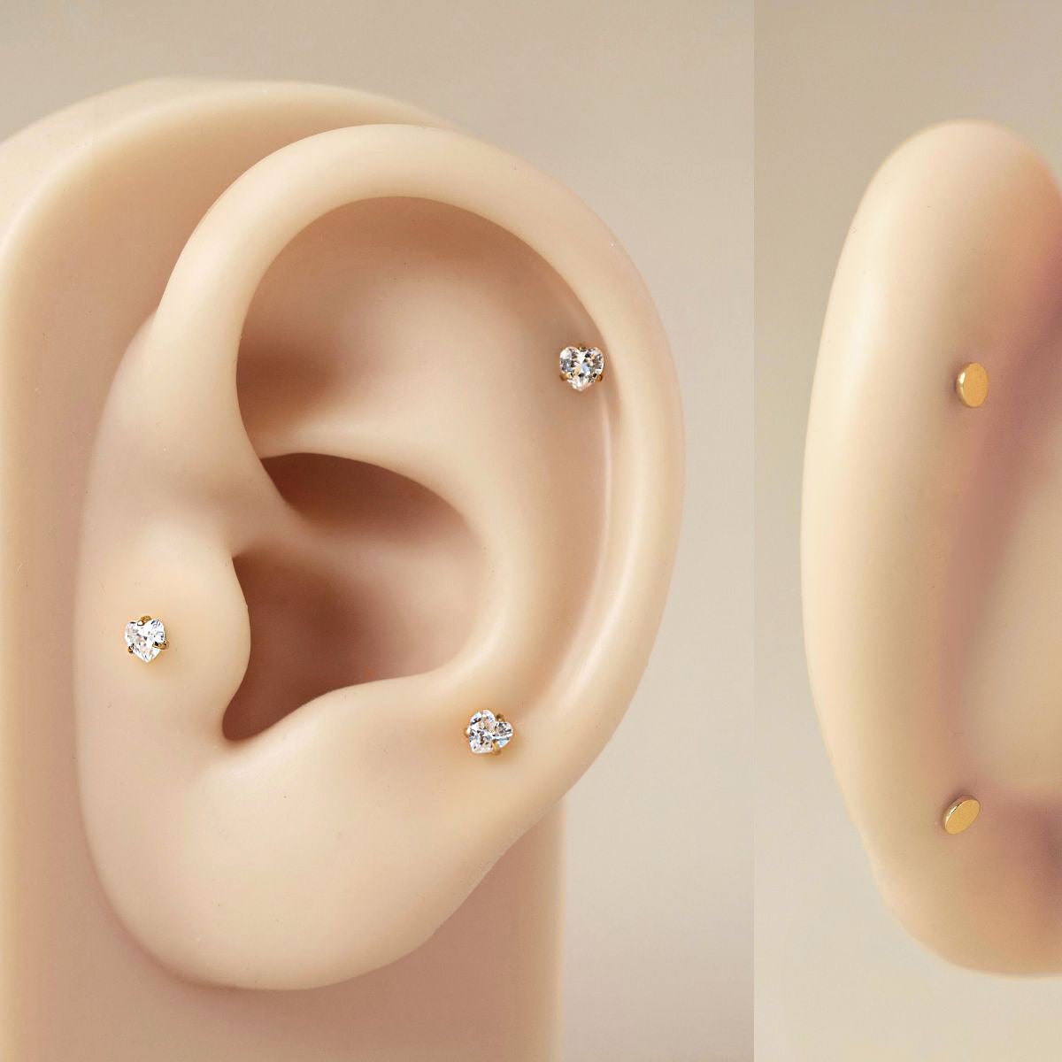 Gold titanium heart flat back studs on a silicone ear model as a placement guide, two views