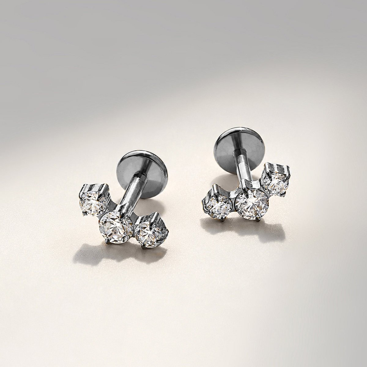 Titanium tres curve pavé flat back stud earrings, close-up detail