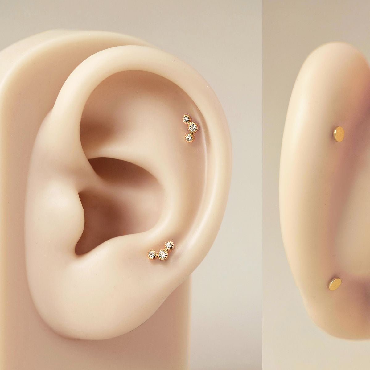 Gold titanium trio bezel flat back stud with white zirconia, shown on a silicone ear, front and side