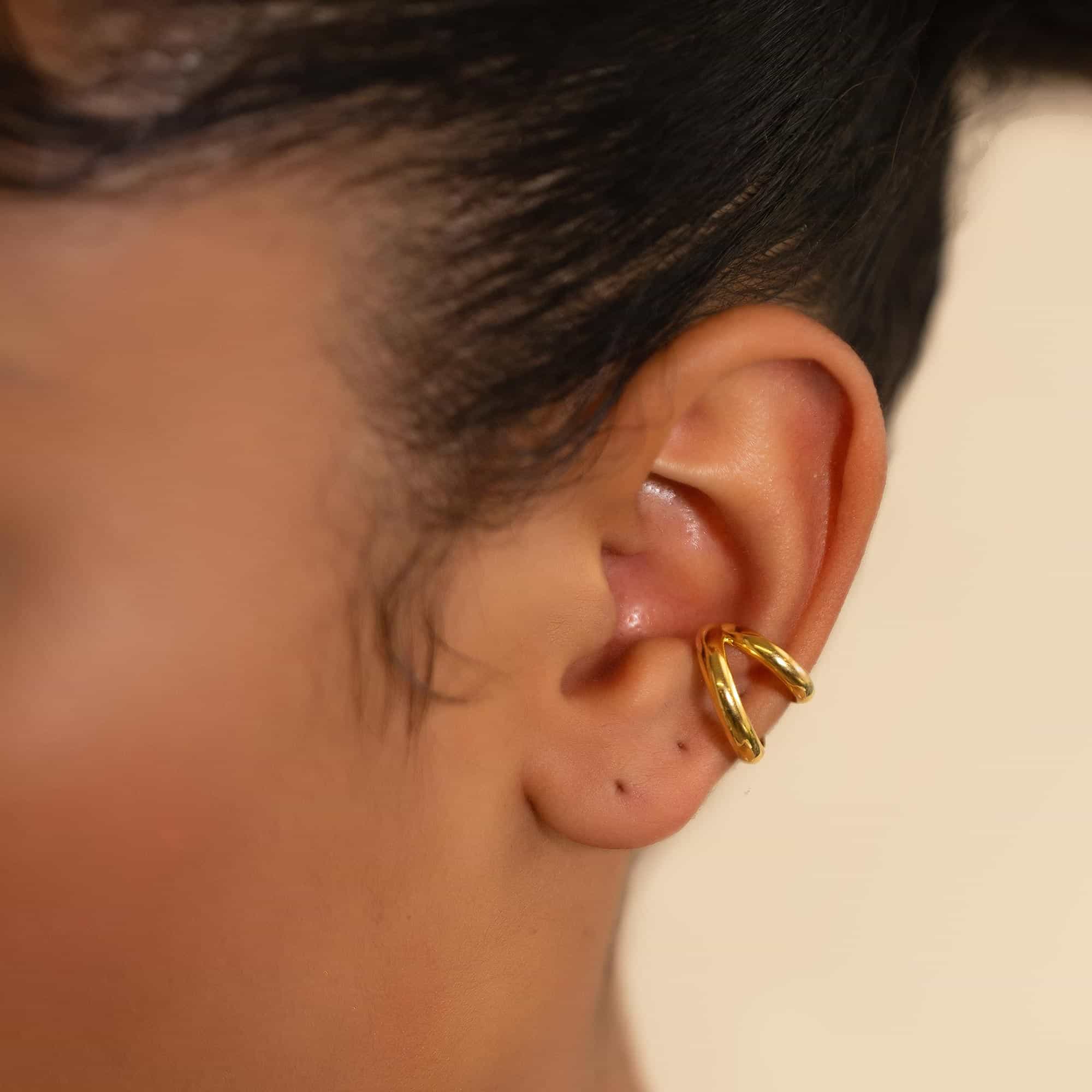 Gold vermeil double-band ear cuff shown on a model's upper ear