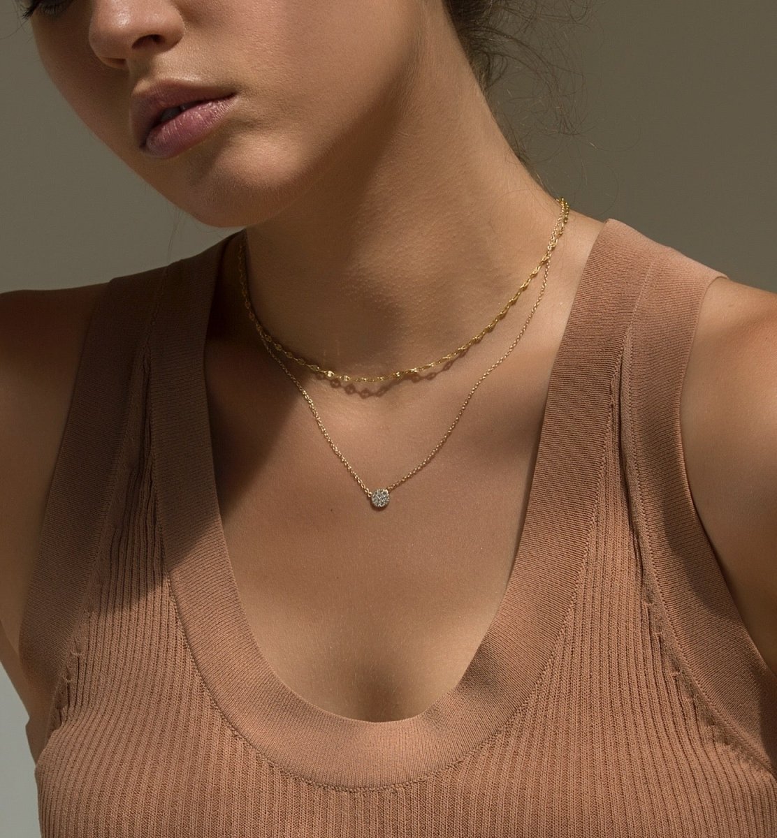Gold vermeil chain choker layered with a pavé pendant necklace, shown on a model's neckline