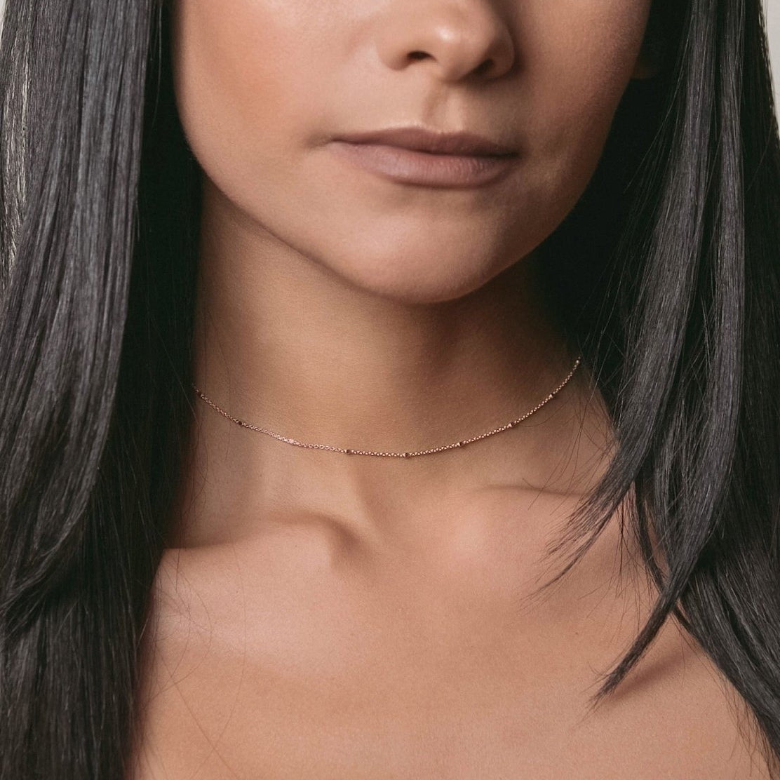 Rose gold vermeil beaded satellite chain choker, shown on a model's neckline
