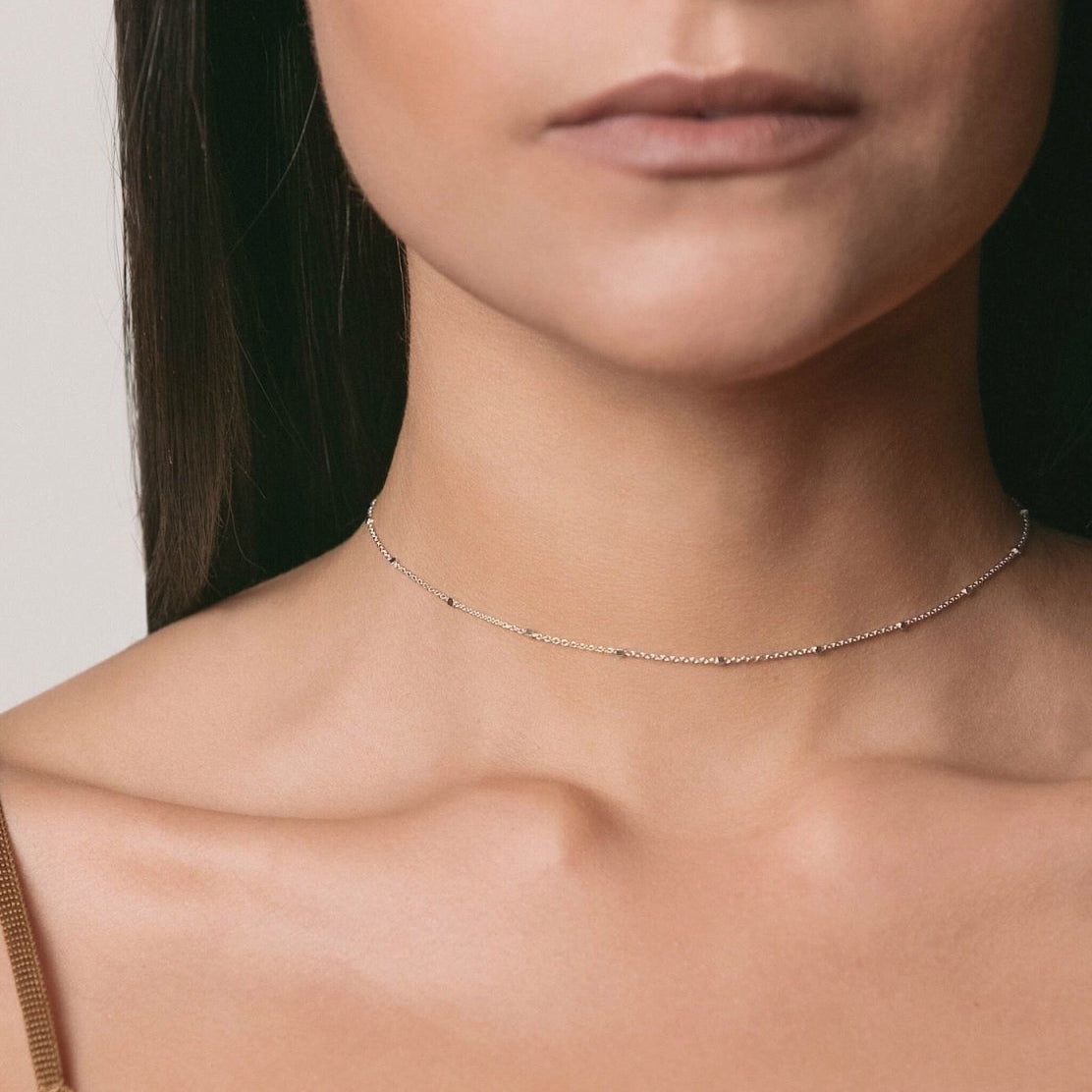 Sterling silver beaded satellite chain choker, close-up detail on a white background