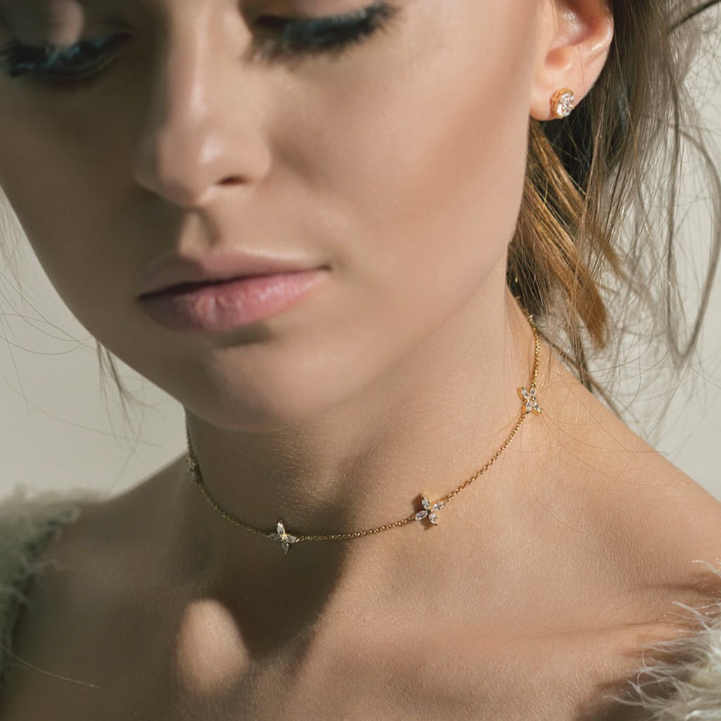 Gold vermeil clear crystal flower choker shown on a model's neck with a matching cluster stud