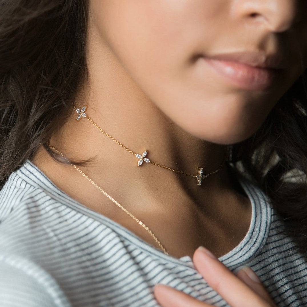Gold vermeil clear crystal flower choker close-up shown on a model's neckline