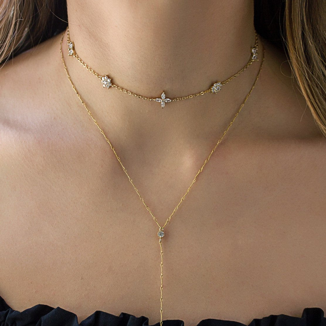 Gold vermeil crystal flower choker layered over a longer chain, shown on a model