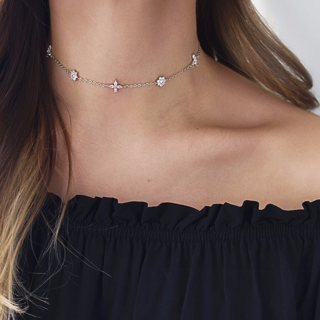 Sterling silver crystal flower choker, close on a model's neckline